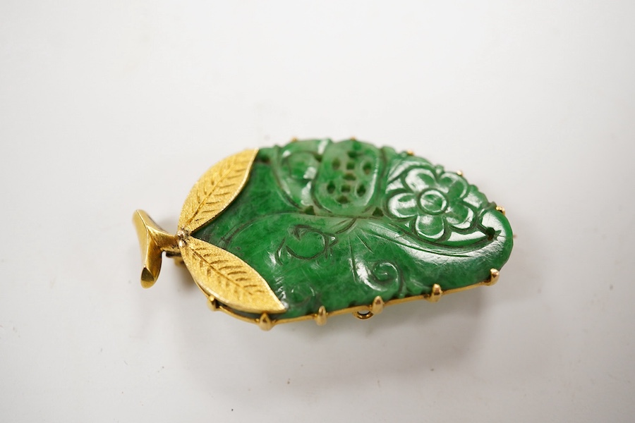 A Chinese yellow metal mounted carved jade leaf brooch, stamped 'TC18', 36mm, gross weight 5.6 grams and a jade and seed pearl set filigree ring. Condition - fair to good